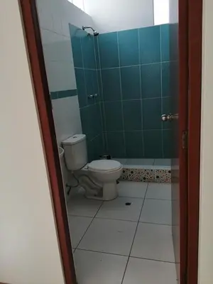 a bathroom with a toilet and a green shower at Apartamento en Ayacucho in Ayacucho