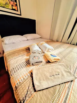 a bed with towels and towels on top of it at Casa Villa Descanso in Lima