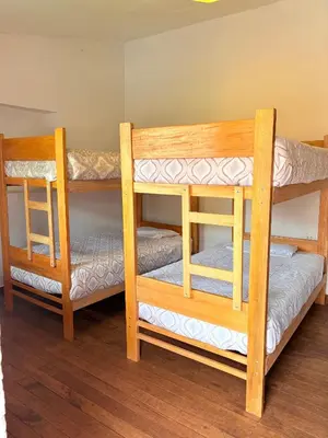 two wooden bunk beds sitting in a room at hostel arcoiris urubamba in Urubamba