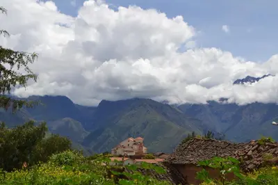 a view of a mountain range with clouds in the sky at Casa Takiy in Maras