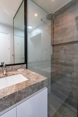 a bathroom with a sink and a glass shower at Plaza 27 by Geko in Lima
