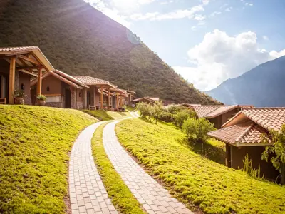 a brick road leading down a hill with houses at Inkaterra Hacienda Urubamba in Urubamba