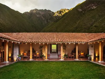 a house with a mountain in the background at Inkaterra Hacienda Urubamba in Urubamba