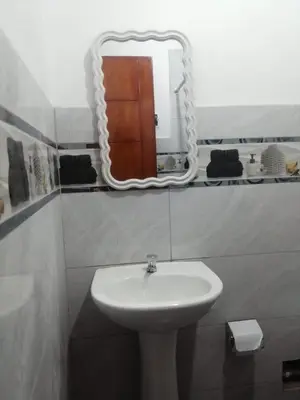 a bathroom with a sink and a mirror at Alojamiento Miller in Ayacucho