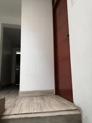 an empty room with a door and a wooden floor at Alojamiento Miller in Ayacucho