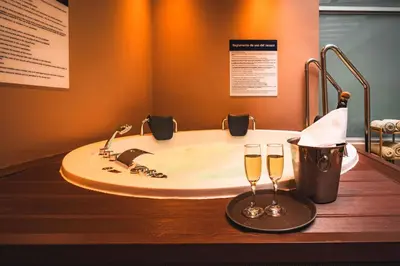 a bathroom with a sink and two glasses of champagne at Hampton By Hilton Cusco in Cusco