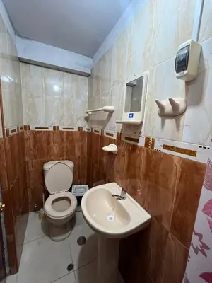 a bathroom with a toilet and a sink at Habitación con baño privado in Ayacucho