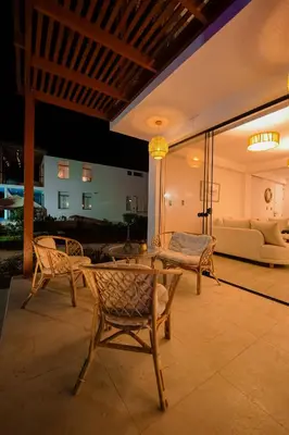 a patio with chairs and a couch and a table at Casa de playa en Chincha Baja in Chincha Baja