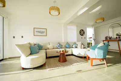 a living room with a couch and two chairs at Casa de playa en Chincha Baja in Chincha Baja