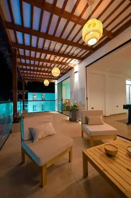 a living room with two couches and a table at Casa de playa en Chincha Baja in Chincha Baja