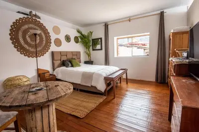a bedroom with a bed and a wooden table at Alojamiento en Centro Histórico Cusco in Cusco