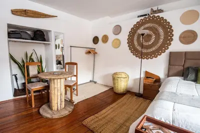 a living room with a table and a bed at Alojamiento en Centro Histórico Cusco in Cusco