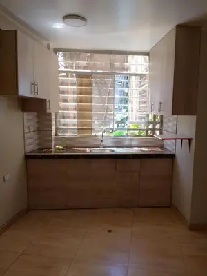 an empty kitchen with a sink and a window at Macchi in Ayacucho