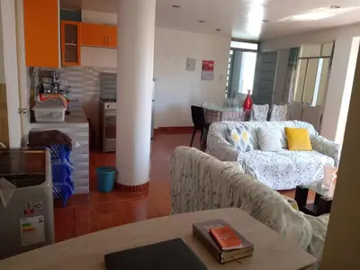 a living room with a couch and a table at Macchi in Ayacucho