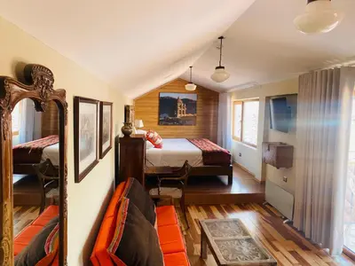 a bedroom with a bed and a mirror in a room at Artinka Boutique Hotel in Cusco
