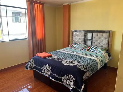a bedroom with a bed and a window at Habitación 2 camas y baño privado in Ayacucho