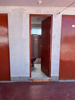 an open door to a bathroom with a toilet at Habitación 2 camas in Ayacucho