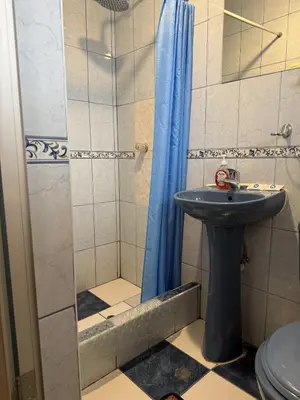 a bathroom with a sink and a shower at Naty's Guest House in Cusco
