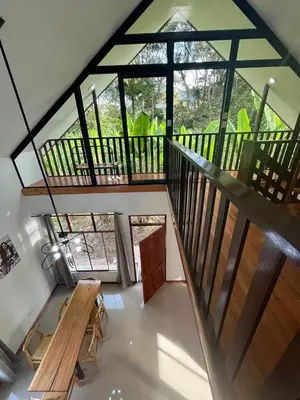 a room with a staircase and a table and a bench at Albano Casa en bosque de conservación privado in Oxapampa
