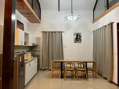 a dining room with a table and chairs in a kitchen at Albano Casa en bosque de conservación privado in Oxapampa