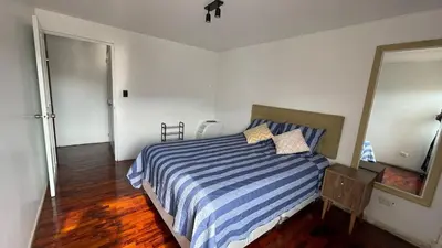 a bedroom with a blue and white striped bed at Brand new modern apartment in Lima