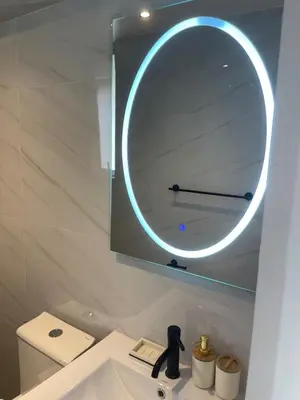 a bathroom with a mirror above a sink at Brand new modern apartment in Lima