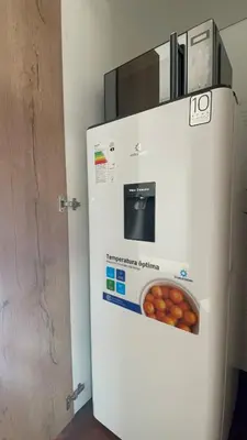a refrigerator with a box of donuts on it at Brand new modern apartment in Lima