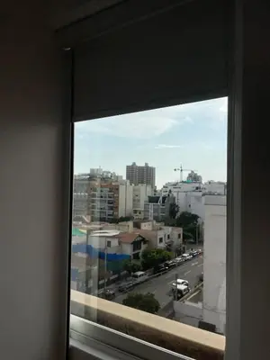 a window with a view of a city street at Brand new modern apartment in Lima