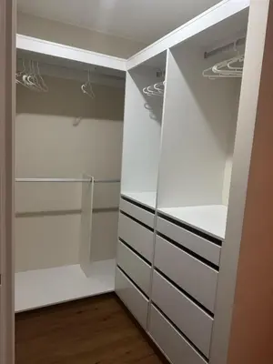 a walk in closet with white cabinets and drawers at Beautiful brand new apartment in an excellent area in Lima