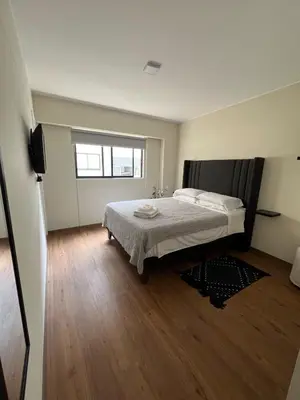 a bedroom with a bed and a television in it at Beautiful brand new apartment in an excellent area in Lima