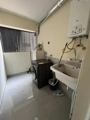 a bathroom with a sink and a washing machine at Beautiful brand new apartment in an excellent area in Lima