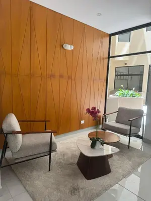 a living room with two chairs and a table at Beautiful brand new apartment in an excellent area in Lima