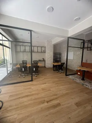 an empty office with tables and chairs and a large window at Beautiful brand new apartment in an excellent area in Lima