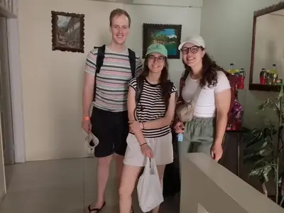 a family posing for a picture in a room at Hospedaje El Cairo in Ica