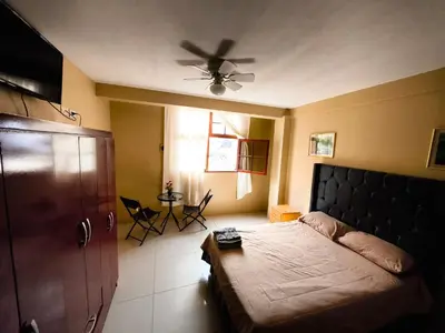 a bedroom with a bed and a ceiling fan at Hospedaje El Cairo in Ica