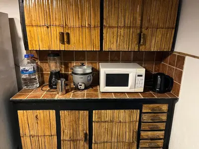 a microwave sitting on top of a counter at Playa El Silencio House Facing the Sea in Bombiso