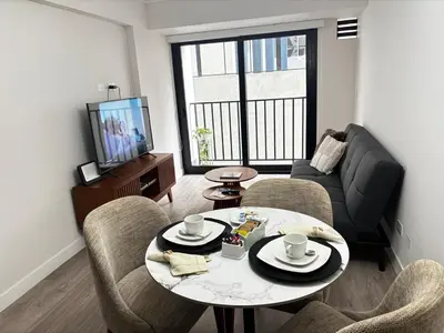 a living room with a table and chairs and a couch at Apartamento en Miraflores in Lima
