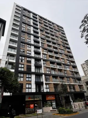 a large apartment building with balconies on a city street at Apartamento en Miraflores in Lima