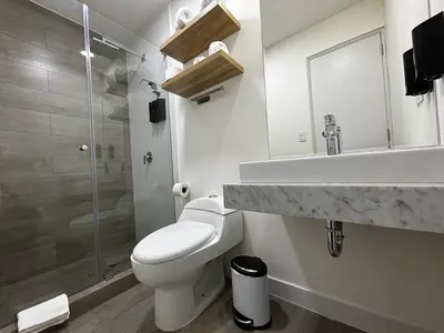 a bathroom with a toilet and a sink and a shower at Apartamento en Miraflores in Lima