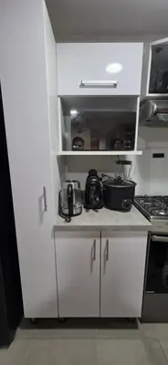 a kitchen with white cabinets and a stove at Departamento 3 Dormitorios en Ñaña - Con Cochera in Chosica