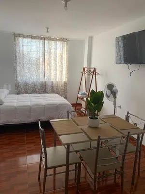 a bedroom with a bed and a table and chairs at Minidepartamentos Amoblado I en Estreno in Ica