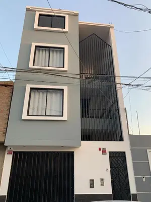 a building with two windows and black gates at Minidepartamentos Amoblado III en Estreno in Ica
