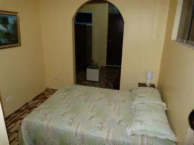 a bedroom with a bed and a large mirror at Matryoshka in Ica