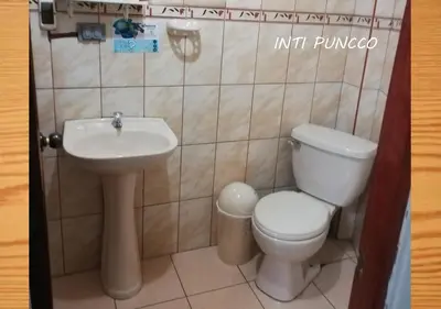 a bathroom with a toilet and a sink at Hostal Lucerito in Cusco