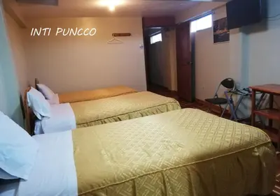 a hotel room with two beds in a room at Hostal Lucerito in Cusco