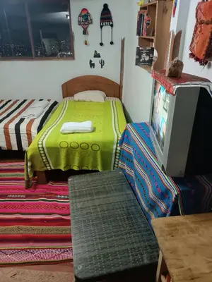 a bedroom with a bed and a tv on a table at San Blas House in Cusco