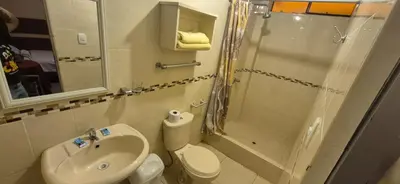 a bathroom with a toilet sink and a shower at Hospedaje Valencia in Ica