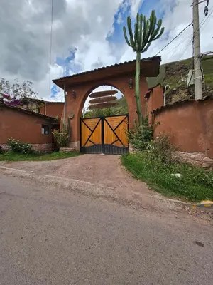 an entrance to a house with a gate with a cactus at Condominio Villa Andina in Urubamba