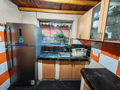 a kitchen with a refrigerator and a sink at Condominio Villa Andina in Urubamba