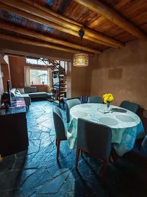a dining room with a table and chairs at Condominio Villa Andina in Urubamba